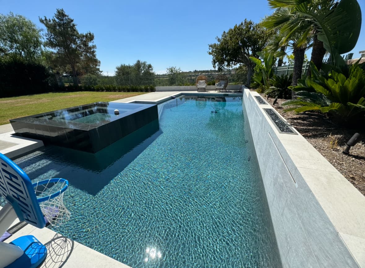 Modern infinity edge pool with spa and landscaping